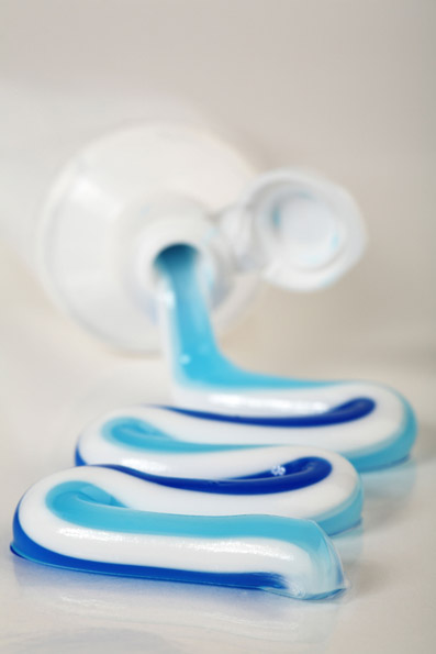 Coloured toothpaste coming out of a tube